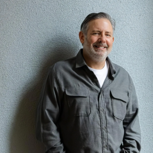 Picture of Phil Shawe in front of a grey wall