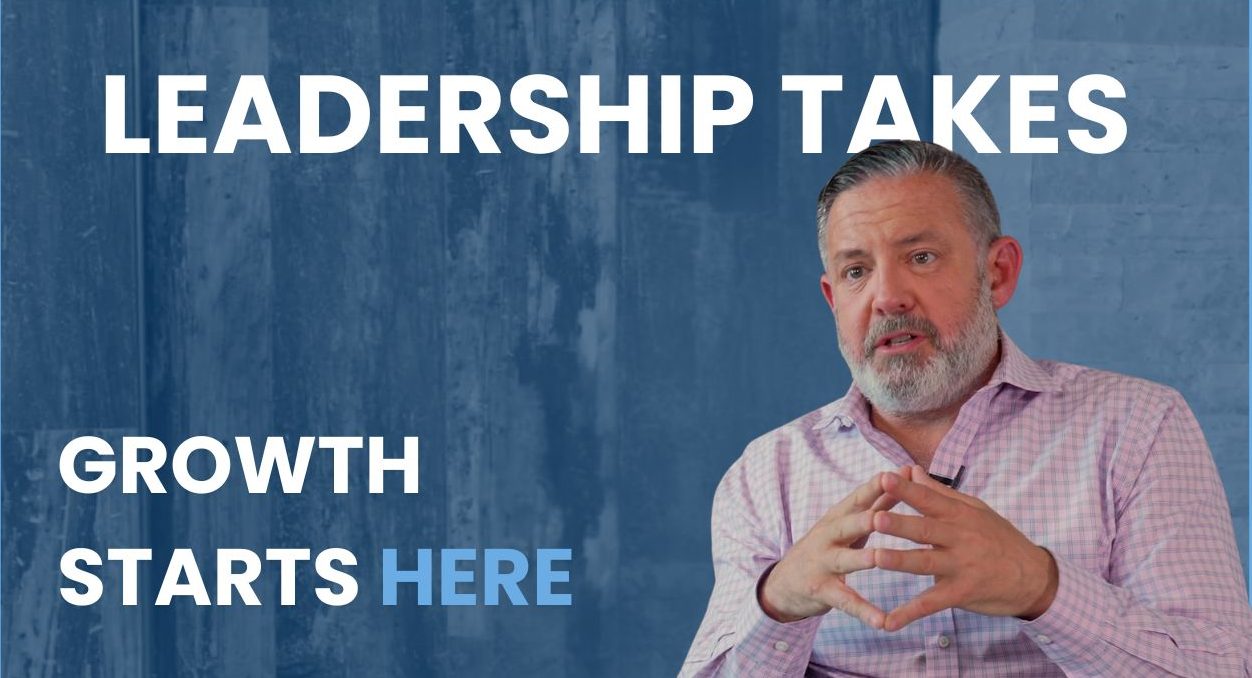 Phil Shawe gesturing in front of a wooden wall with the text reading "growth starts here"